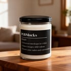 Cozy candle lifestyle scene with wood tones and warm glow