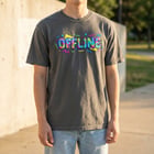 Folded tee on wooden tabletop with styling props